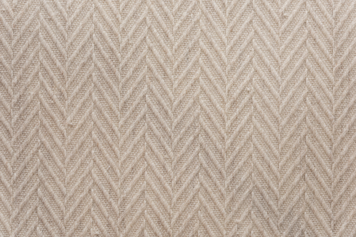 Broadloom carpet in a dimensional herringbone pattern in cream. 
