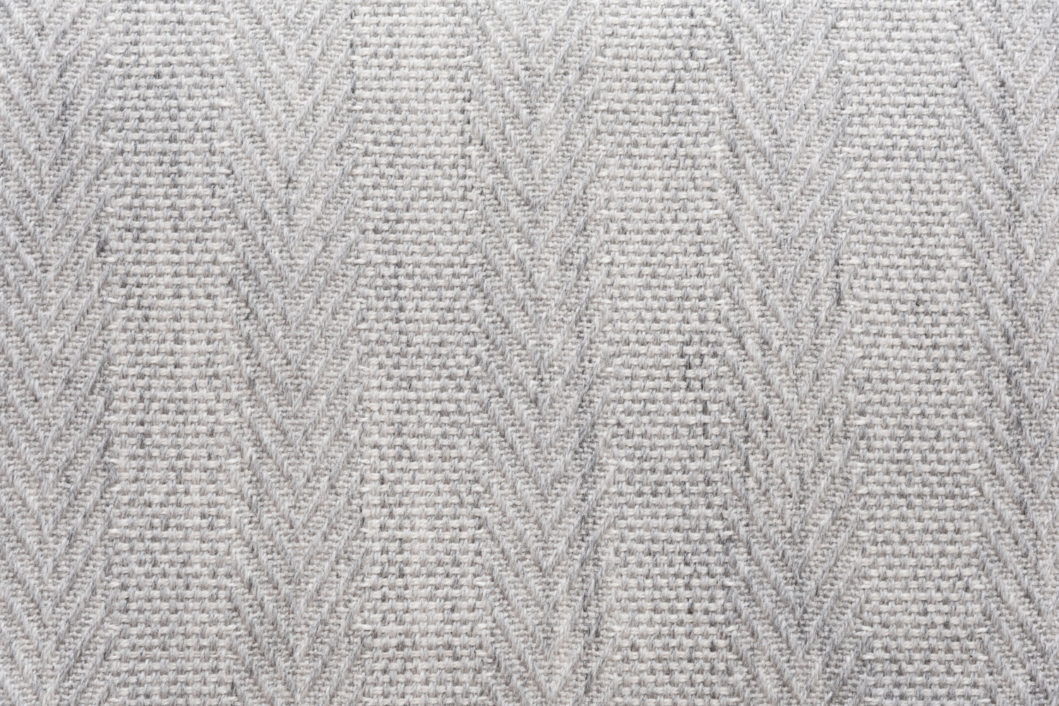 Broadloom carpet in a herringbone stripe in light grey. 