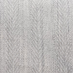 Broadloom carpet in a herringbone stripe in light grey. 