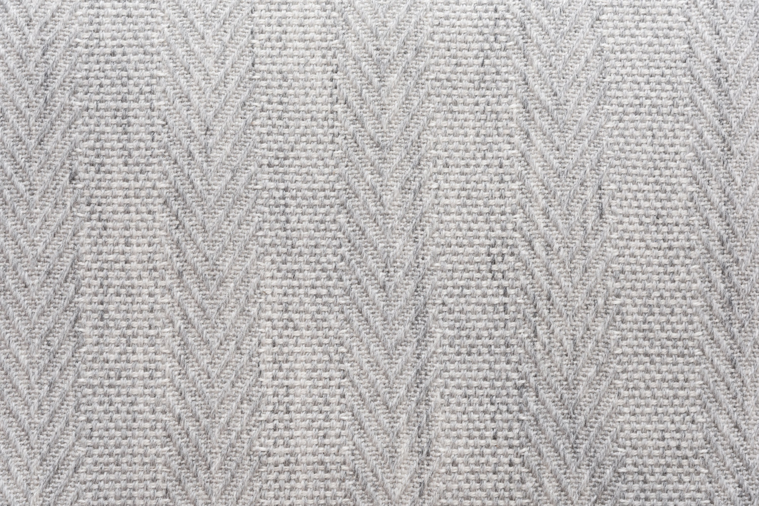 Broadloom carpet in a herringbone stripe in light grey. 