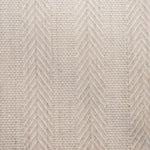 Broadloom carpet in a herringbone stripe in beige. 