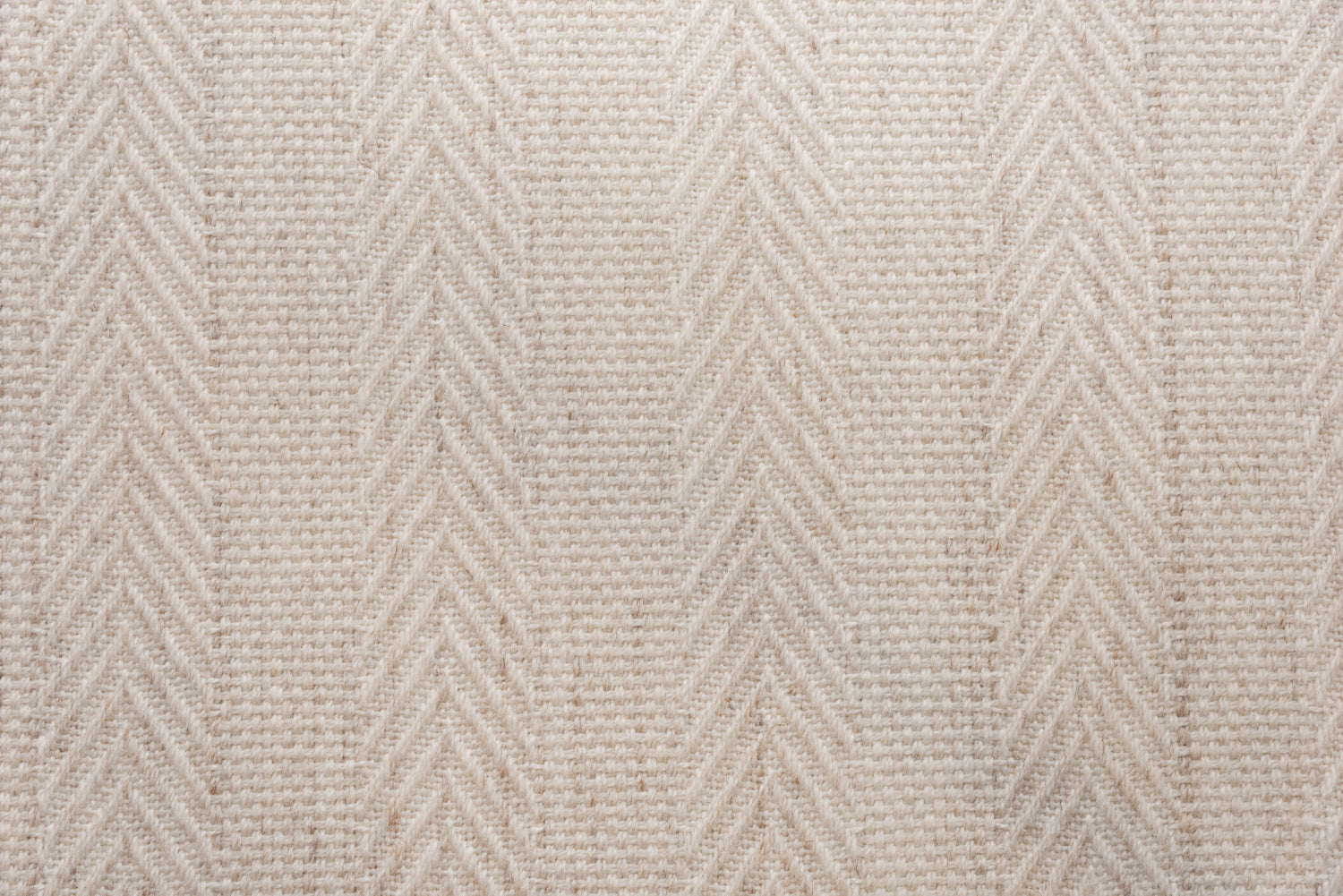 Broadloom carpet in a herringbone stripe in beige. 