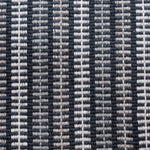 Broadloom carpet in a ticking stripe in shades of grey and white on navy. 