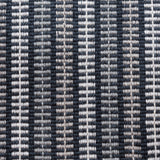 Broadloom carpet in a ticking stripe in shades of grey and white on navy. 