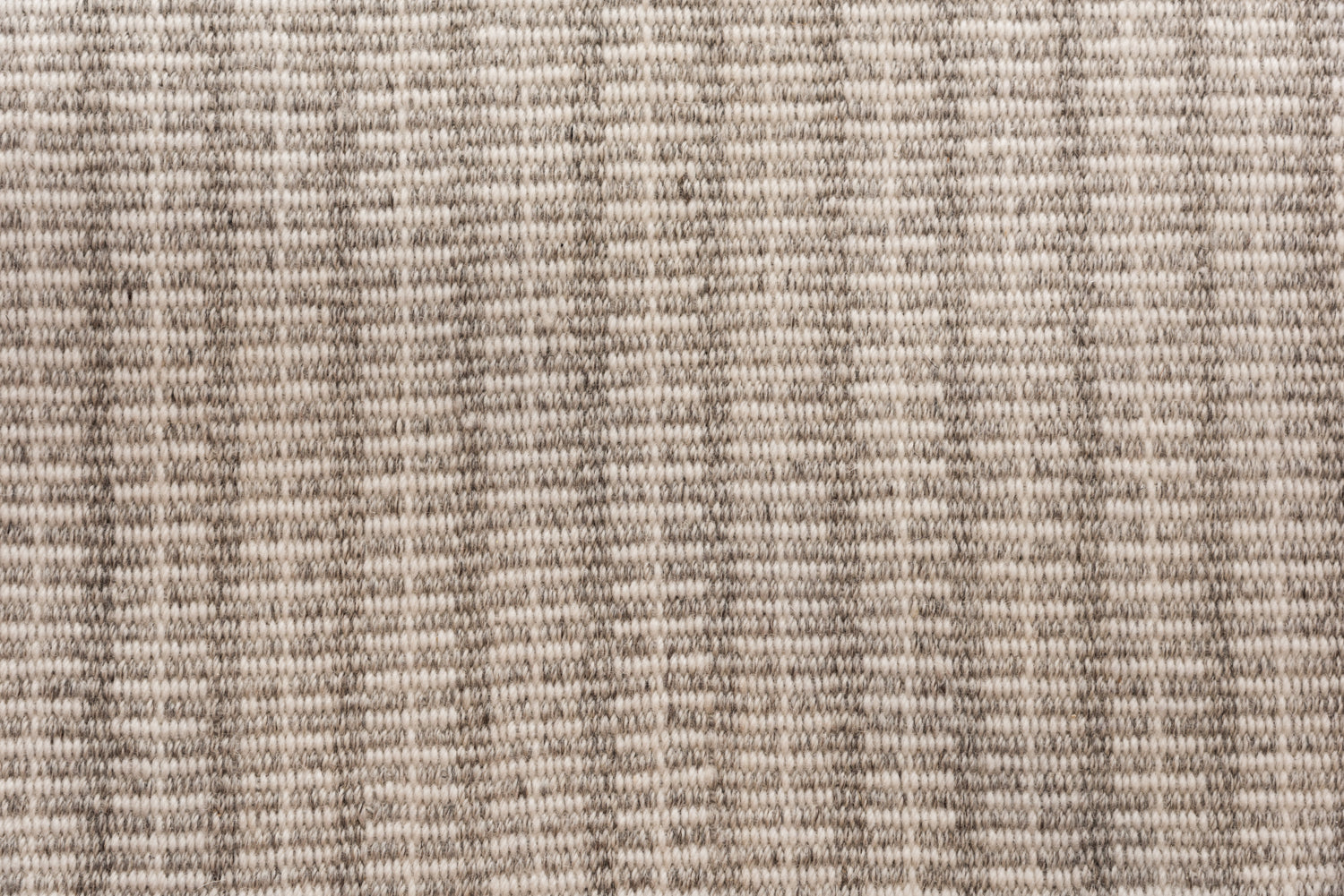 Broadloom carpet in a ticking stripe in shades of strié oatmeal. 