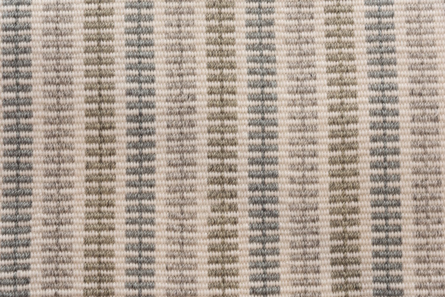 Broadloom carpet in a ticking stripe in shades of grey, beige and taupe. 