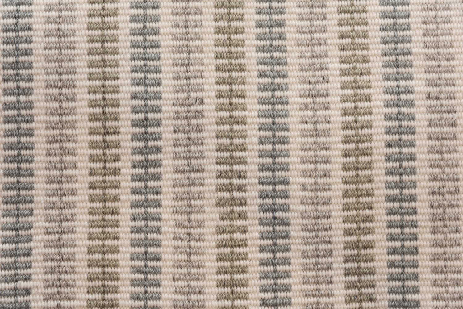 Broadloom carpet in a ticking stripe in shades of grey, beige and taupe. 