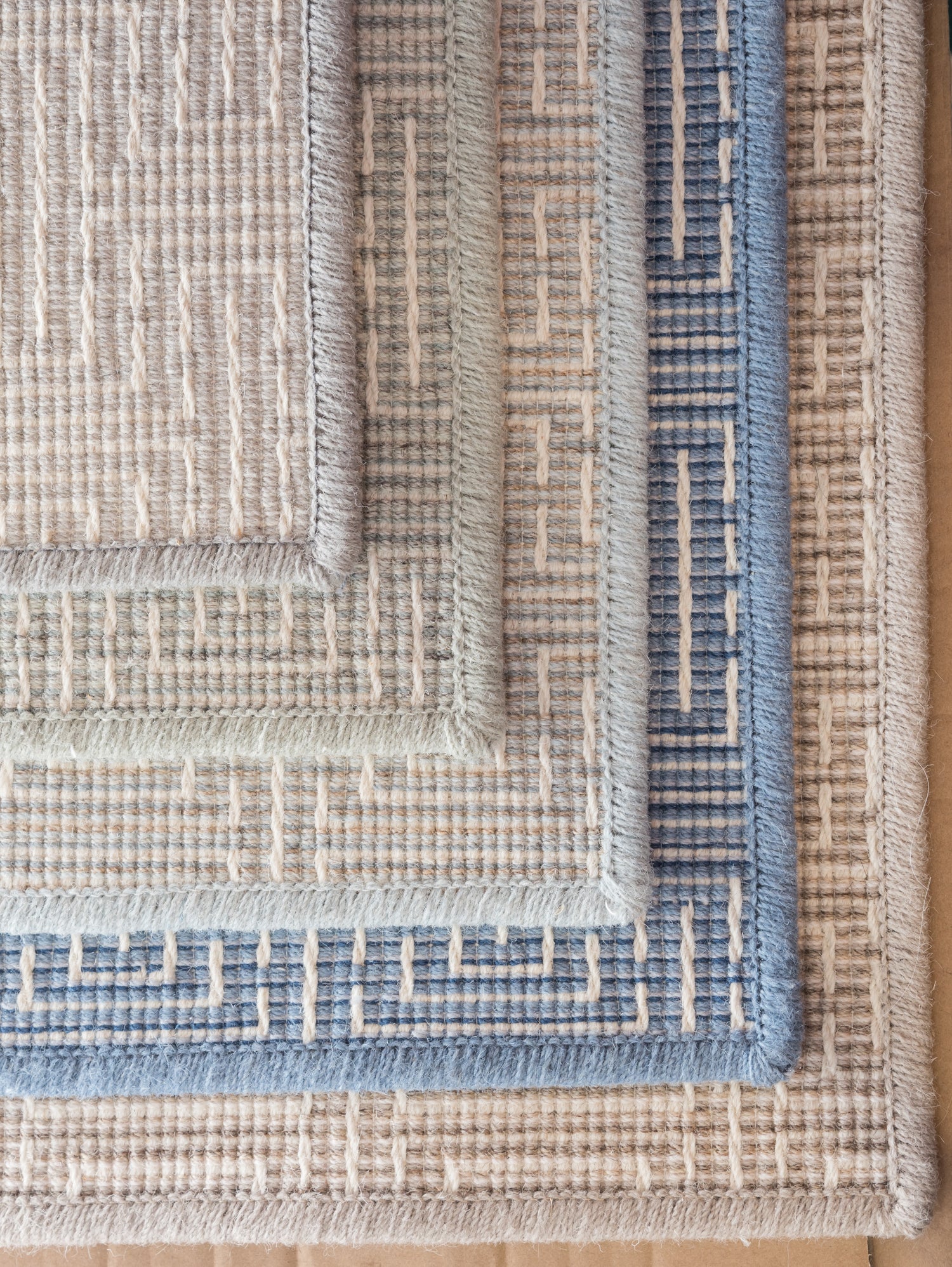 Stack of broadloom carpet samples in a range of colors. 