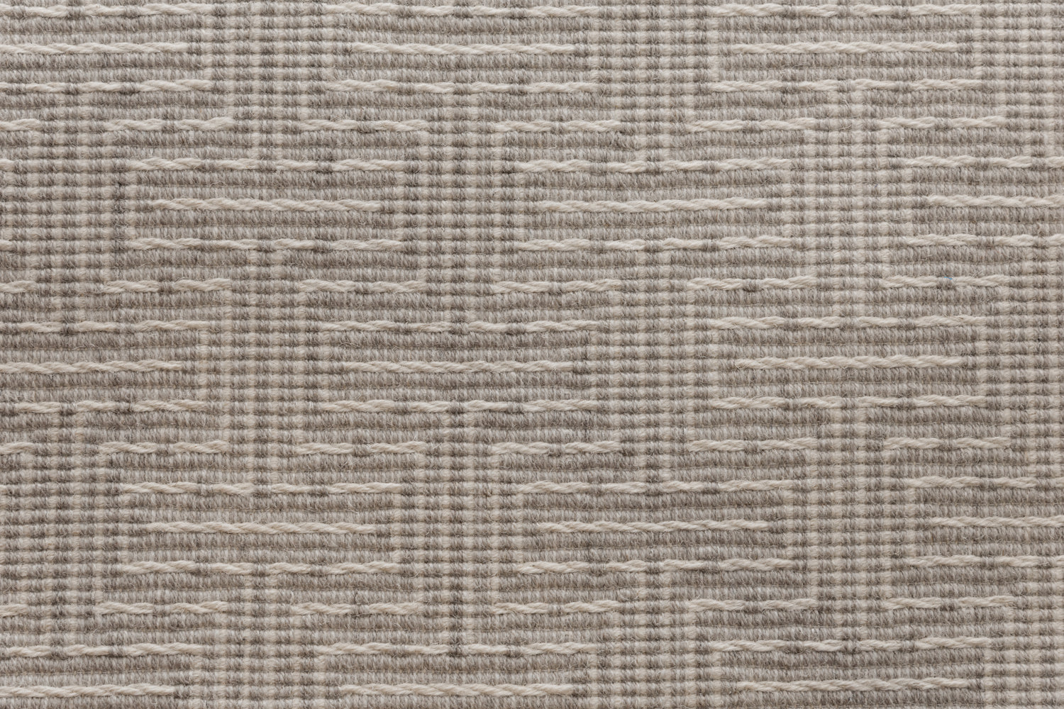 Broadloom carpet in a geometric stripe in cream and taupe. 
