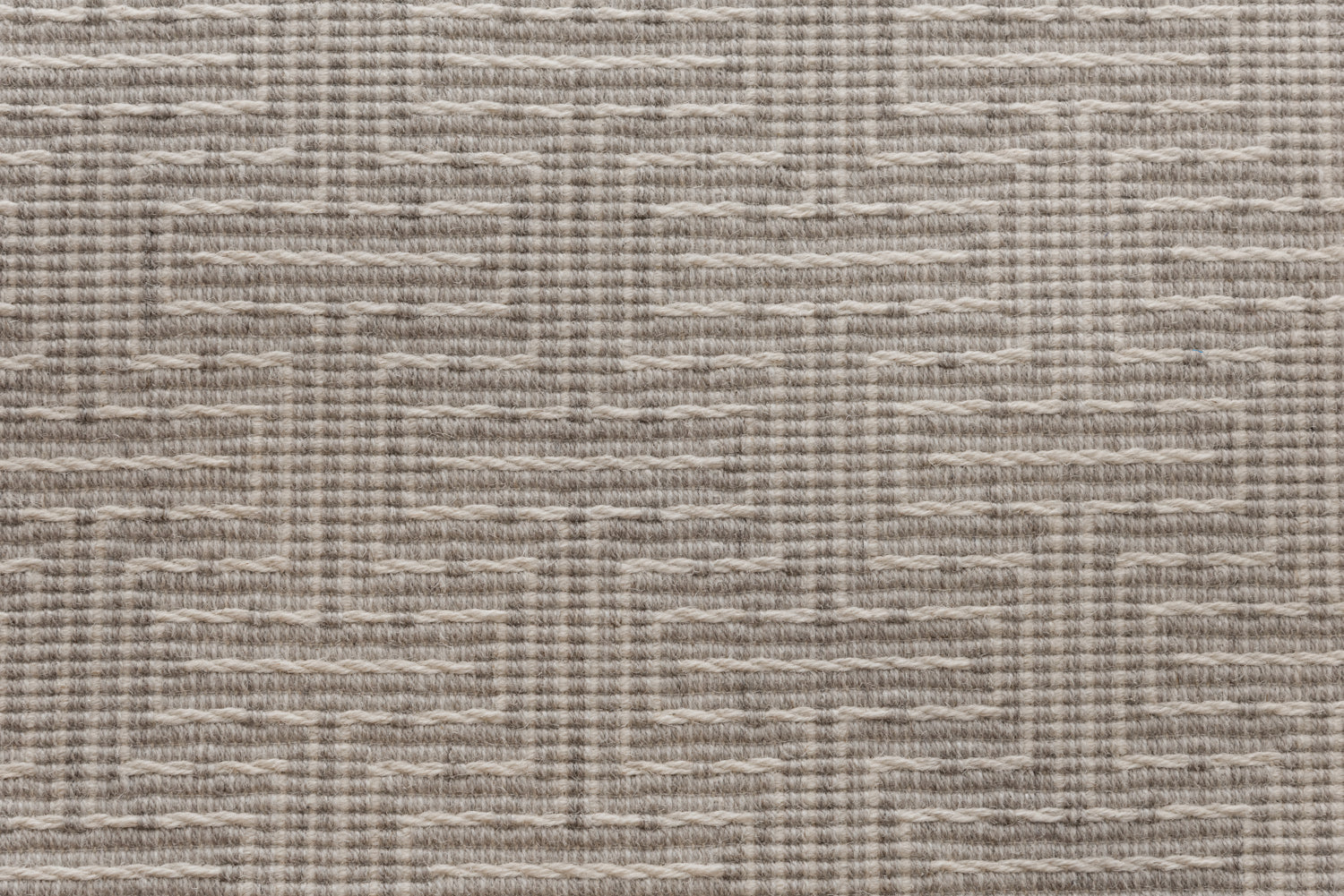 Broadloom carpet in a geometric stripe in cream and taupe. 
