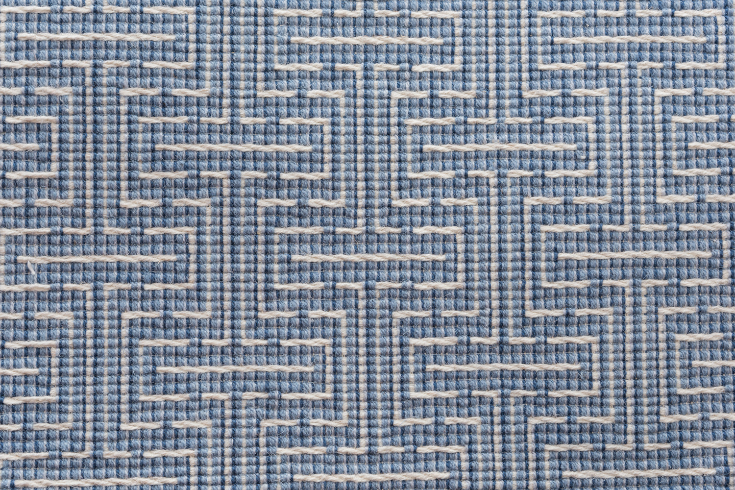 Broadloom carpet in a geometric stripe in cream and shades of blue. 