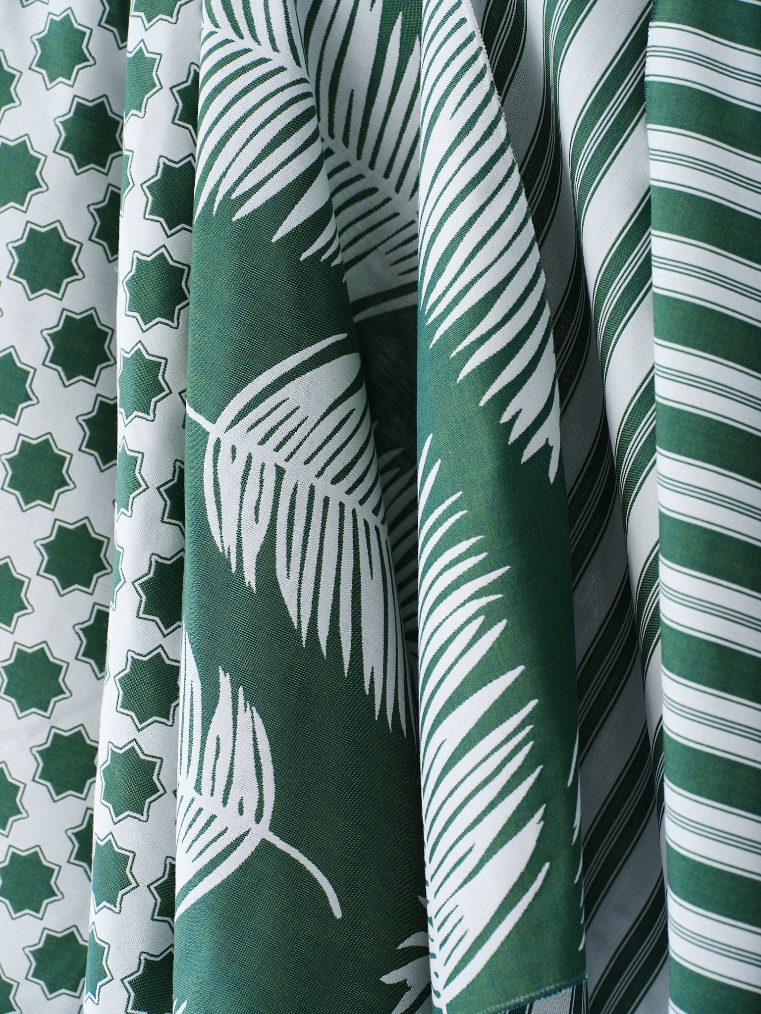 Performance fabrics in green and white in 
a palm print, moroccan star and simple stripe.