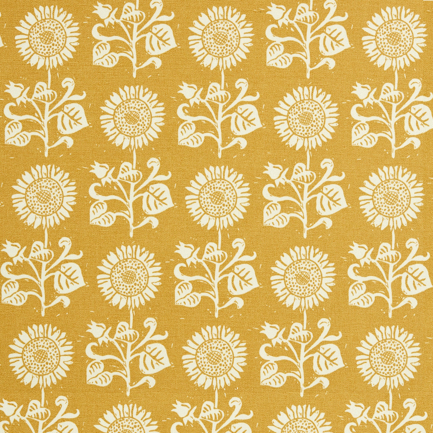 Detail of fabric in a repeating sunflower print in white on a mustard field.