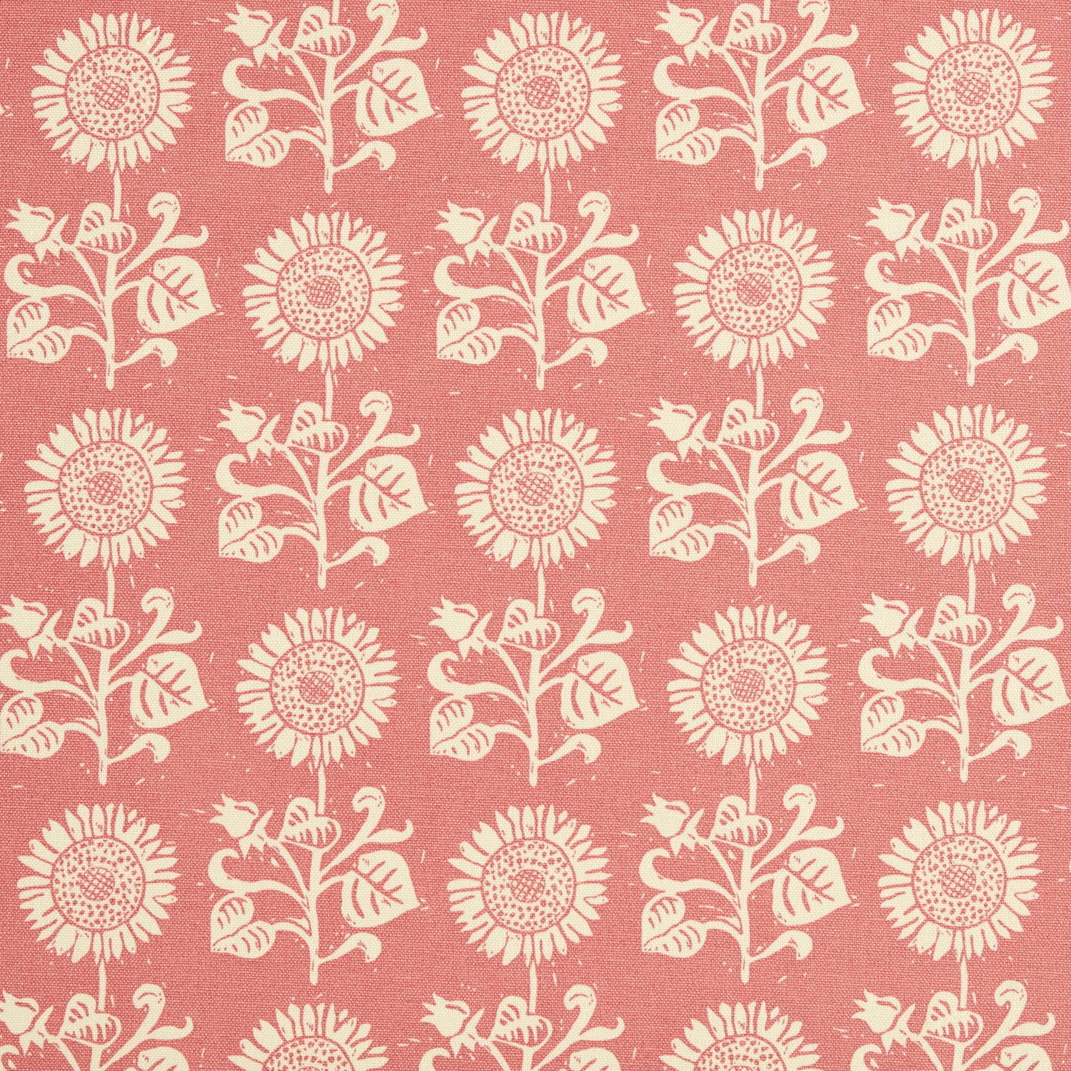 Detail of fabric in a repeating sunflower print in cream on a pink field.