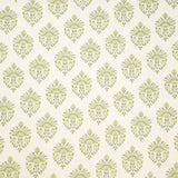 Detail of fabric in a floral paisley print in shades of green on a white field.