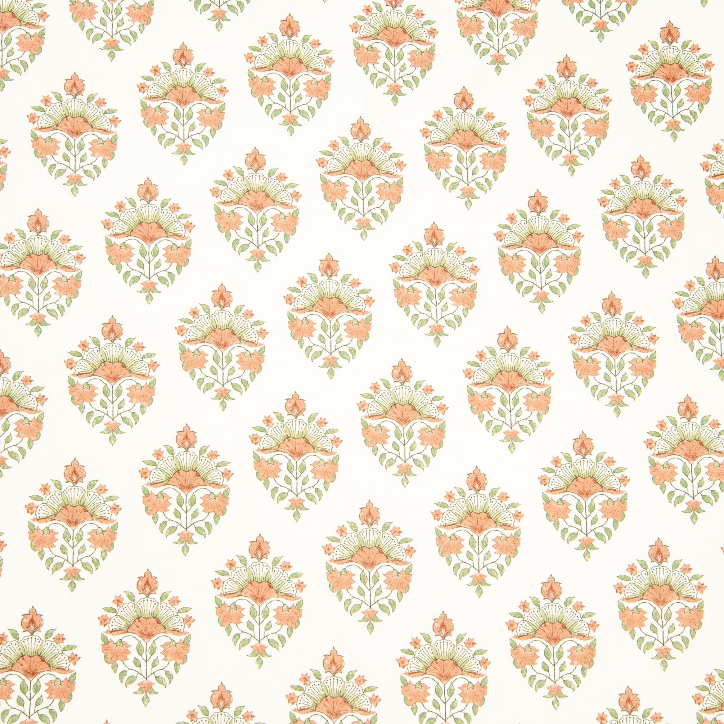 Detail of fabric in a floral paisley print in shades of green and coral on a white field.