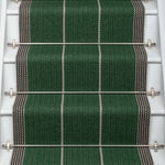 Striped flatweave runner in green and grey on white staircase