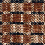 Close-up of a woven plaid rug with brown, black, and beige.