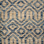 Handwoven carpet in a complex geometric lattice design in shades of blue on a beige field. 