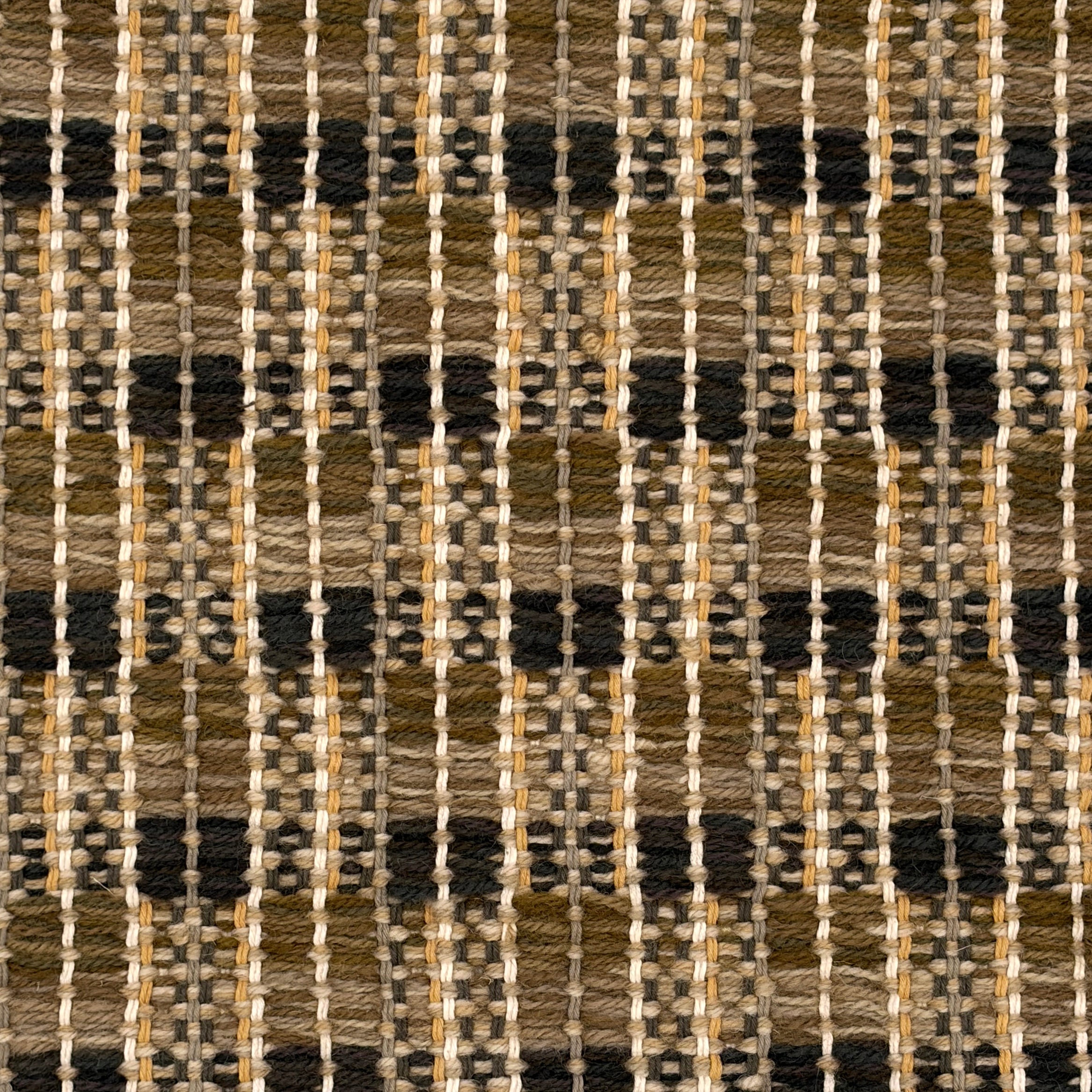 Handowoven rug in textural plaid design in shades of brown, tan and green.