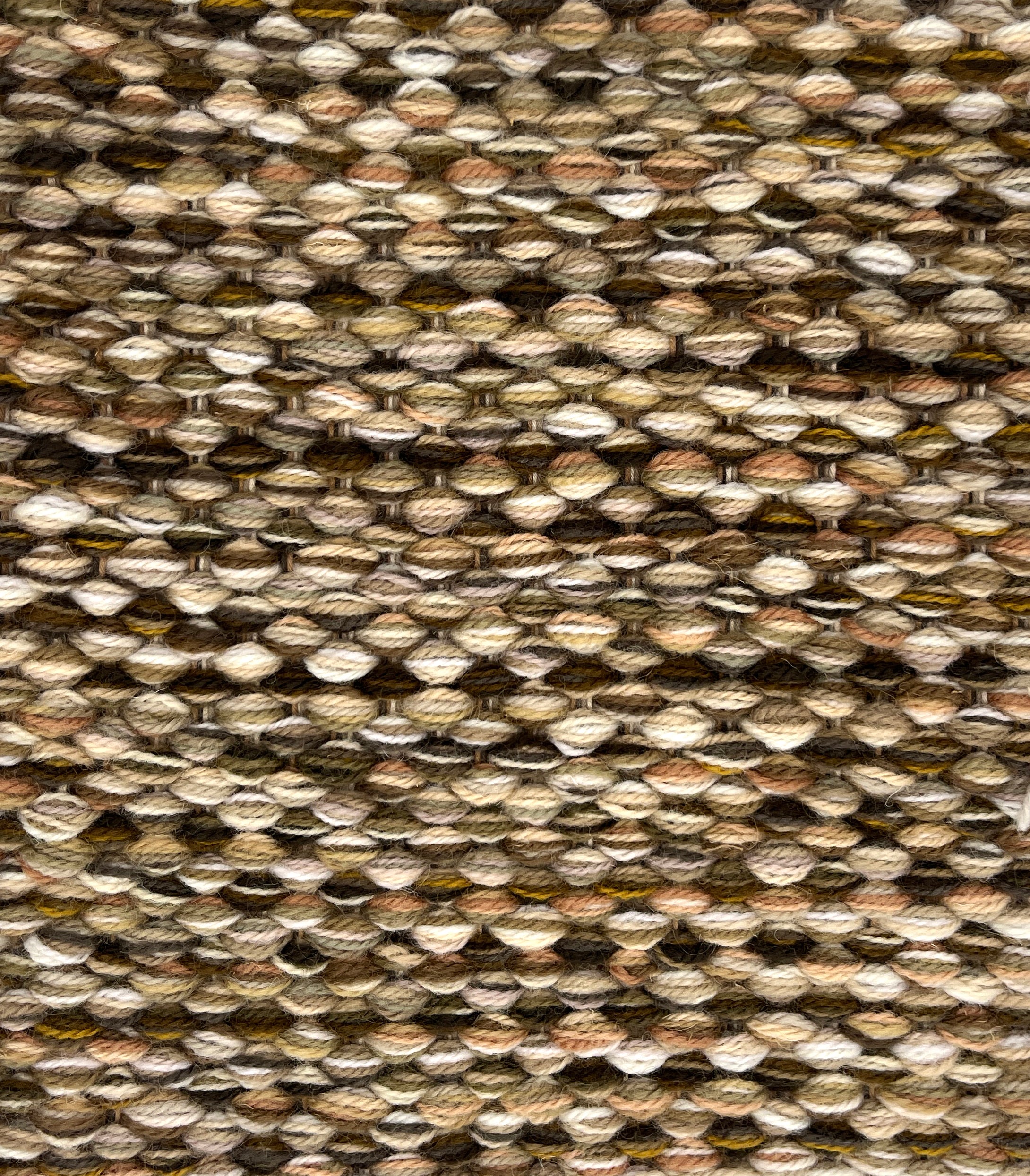 Textured handwoven rug with a strié pattern in brown and beige. 