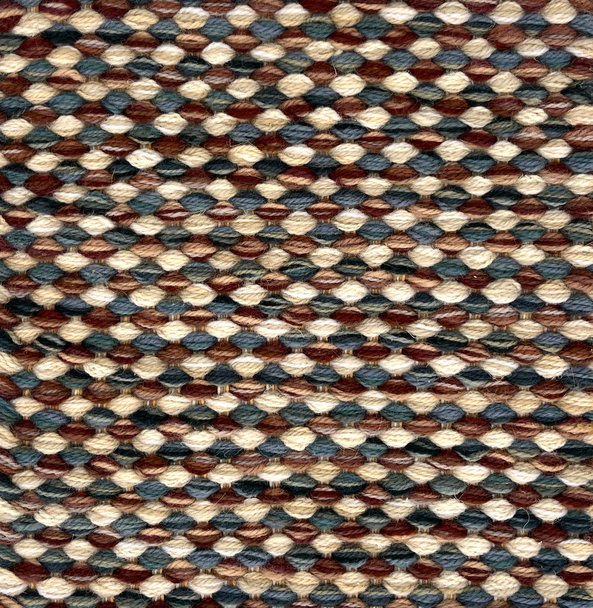 Textured handwoven rug with a strié pattern in brown, beige, and blue colors.
