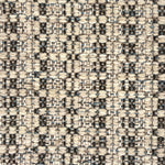 Close-up of a woven rug with textural pattern in shades of grey.