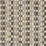 Close-up of a woven rug with textural pattern in shades of grey.