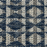 Close-up of a woven rug with geometric pattern in shades of blue.