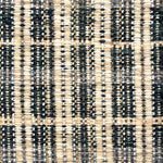 Close-up of a textured teal, cream and beige plaid woven rug. 