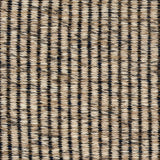A close-up of a woven wool rug a ribbed stripe in shades of beige and charcoal.