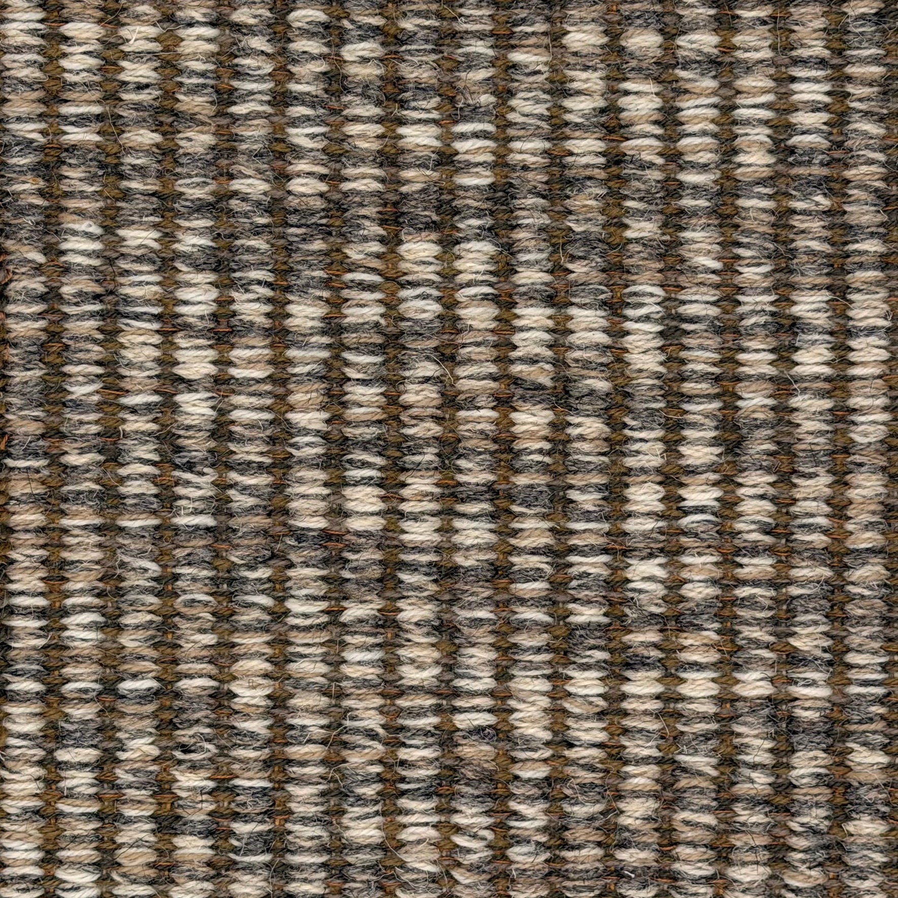 A close-up of a woven wool rug a ribbed stripe in shades of grey, cream and taupe. 