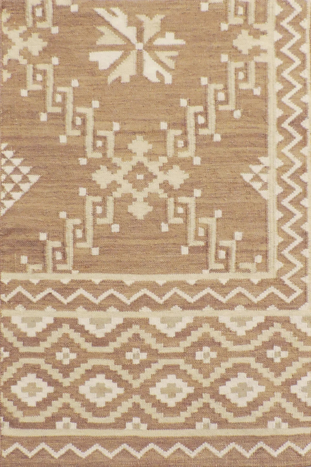 Patterned rug with geometric design in brown and beige tones