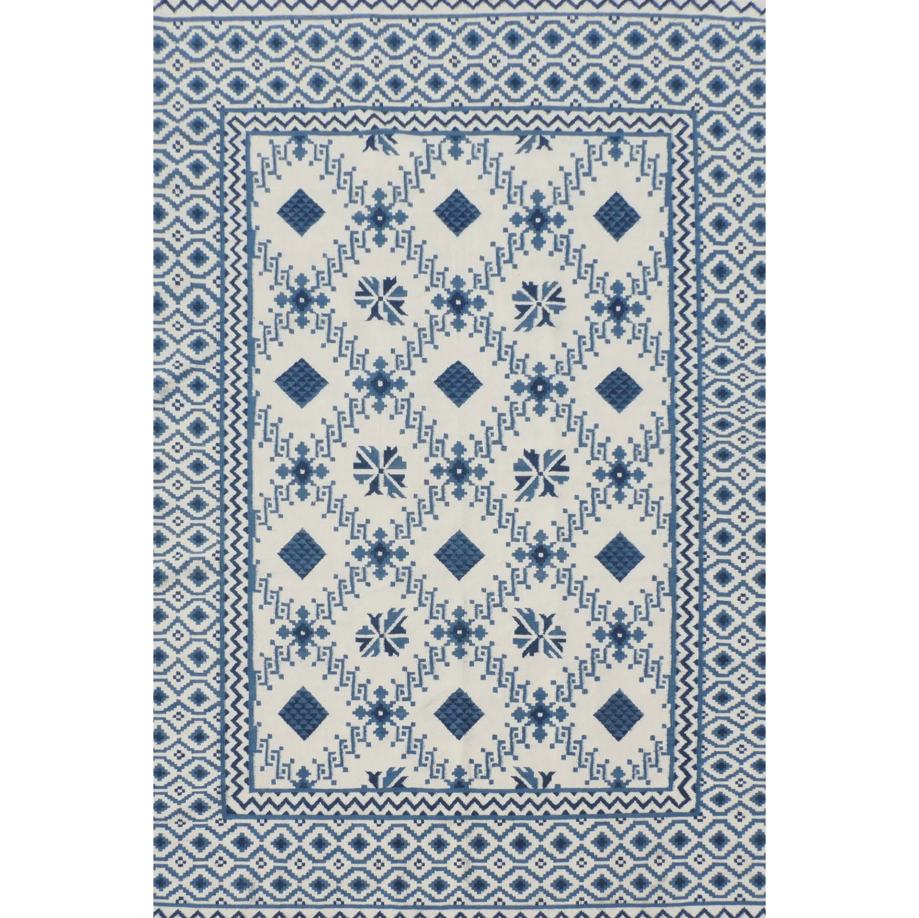 Rug with blue and white geometric pattern on a plain background