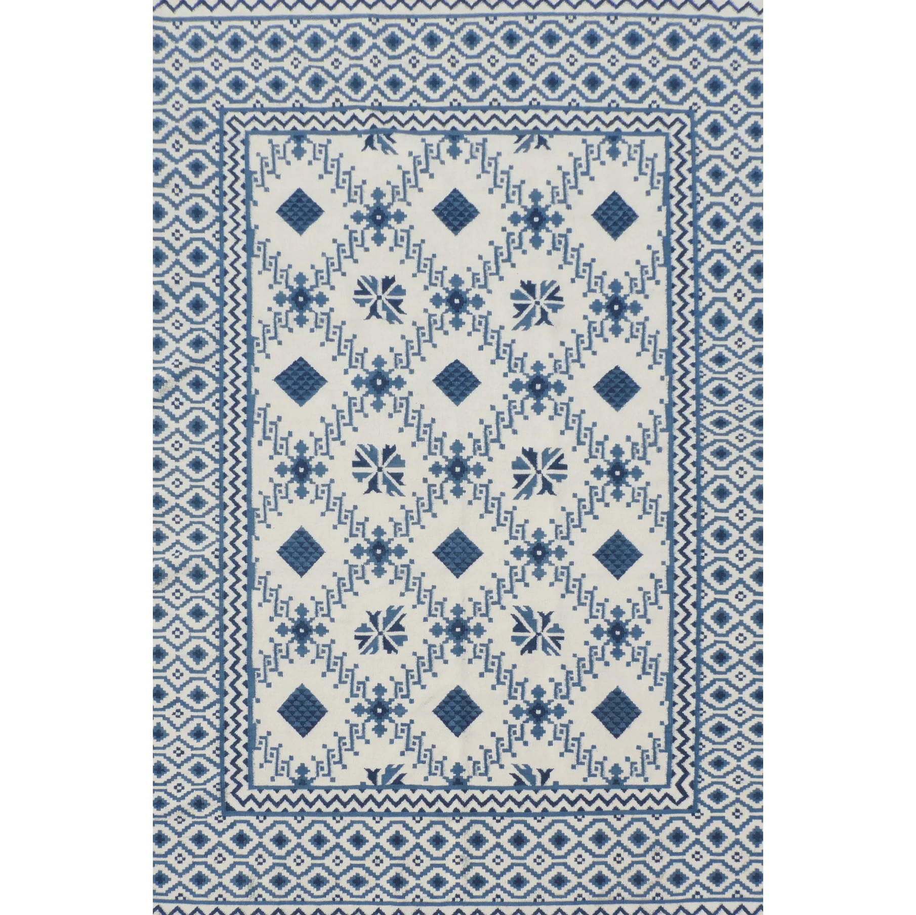 Rug with blue and white geometric pattern on a plain background
