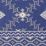 Rug with white geometric pattern on a blue background