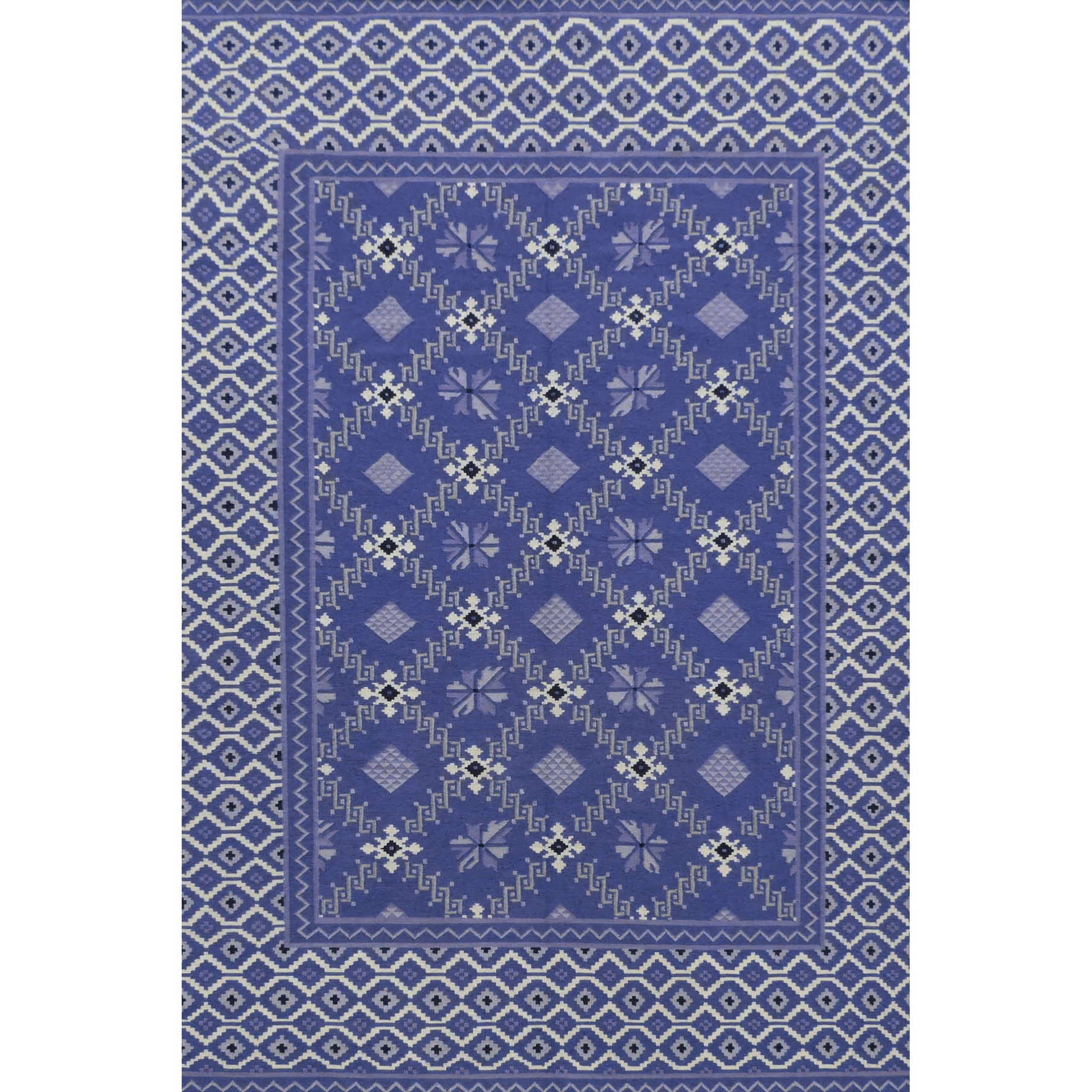 Blue patterned rug with geometric design on a white background