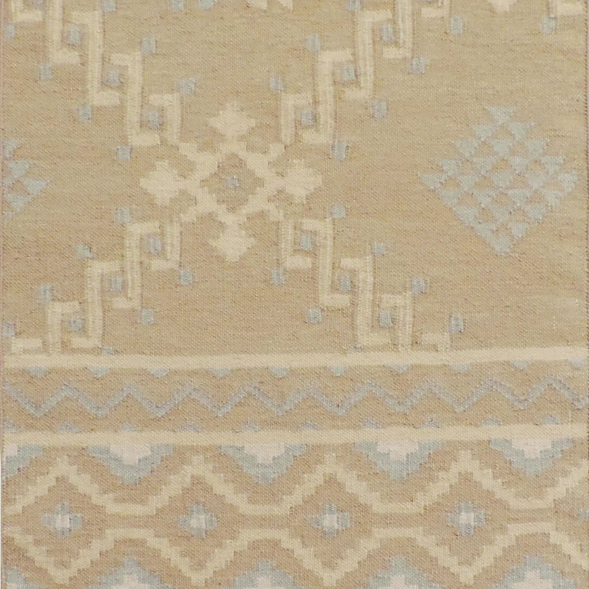 Beige area rug with geometric pattern
