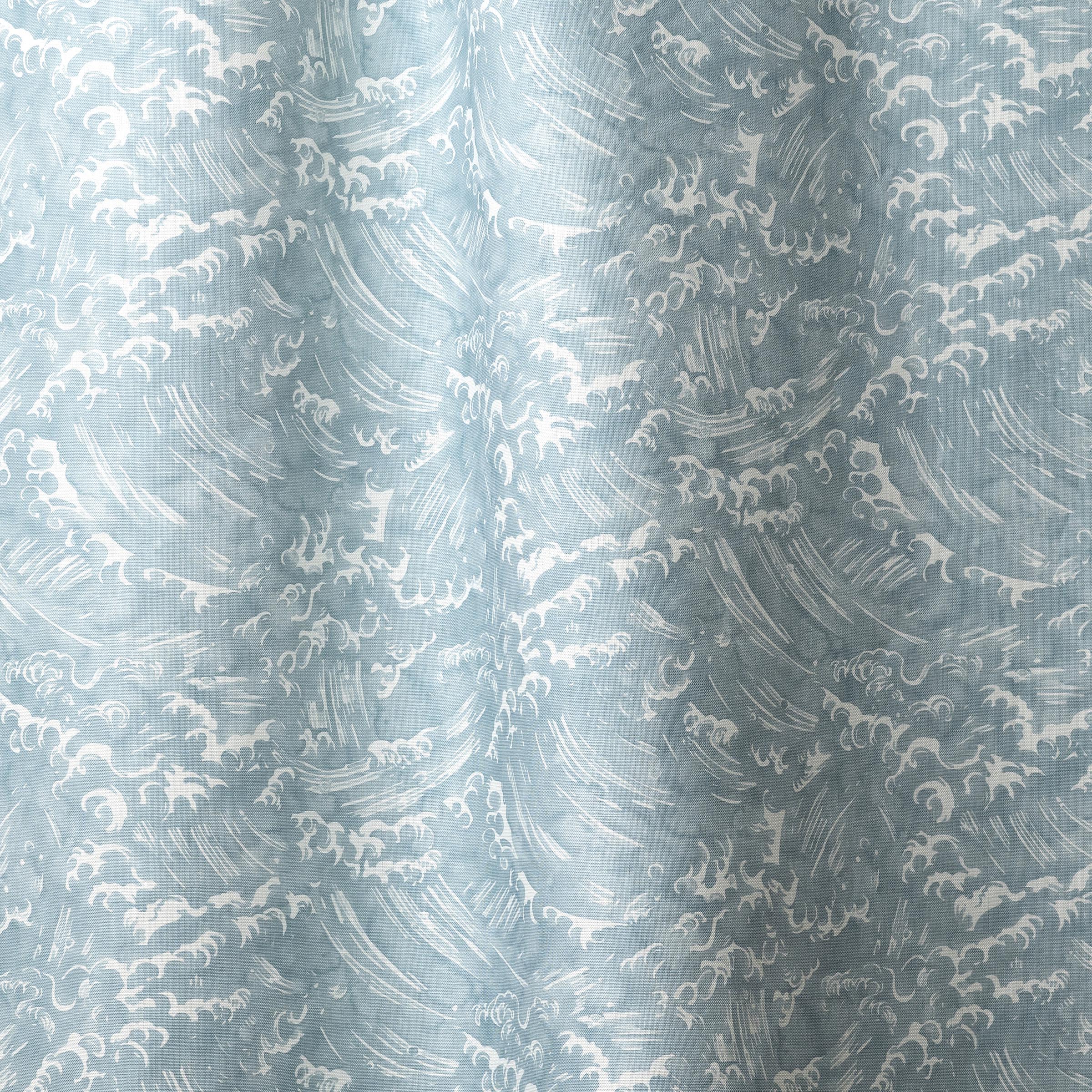 Playful wave print in white on a pastel blue watercolor field.