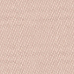 Detail of fabric in a small-scale dot and dash pattern in shades of cream and pink on a light pink field.
