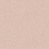 Detail of fabric in a small-scale dot and dash pattern in shades of cream and pink on a light pink field.