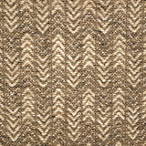 Handwoven rug detail in a herringbone design in tan and beige