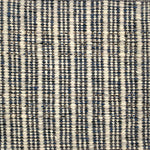Handwoven rug detail in a stripe design in black and white