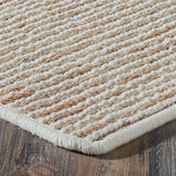Textured beige rug on a wooden floor