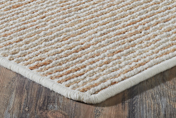 Textured beige rug on a wooden floor