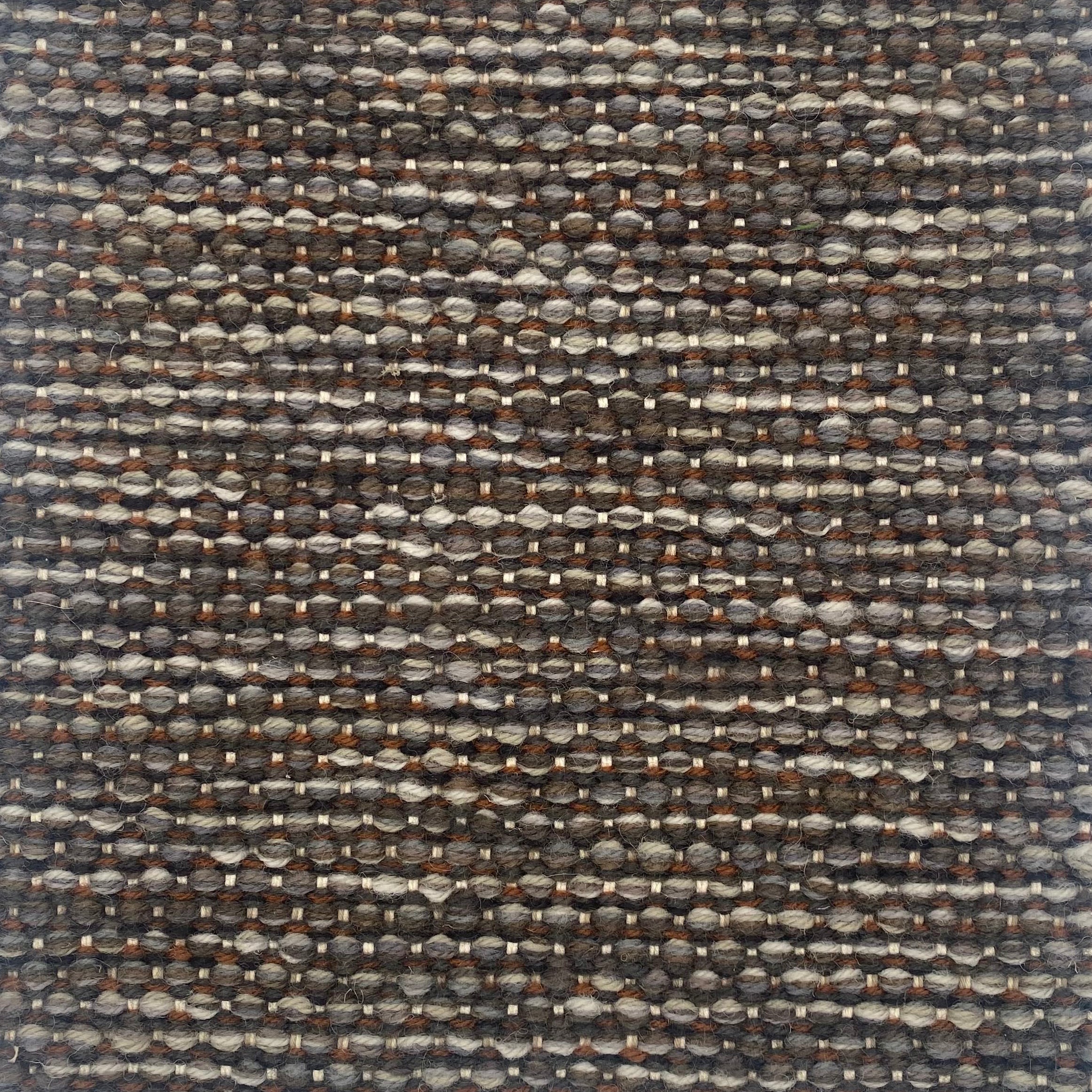 Textured handwoven carpet with a mix of brown and gray colors