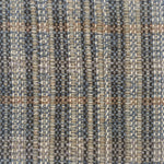 Close-up of a textured rug with a plaid pattern in shades of brown and gray.