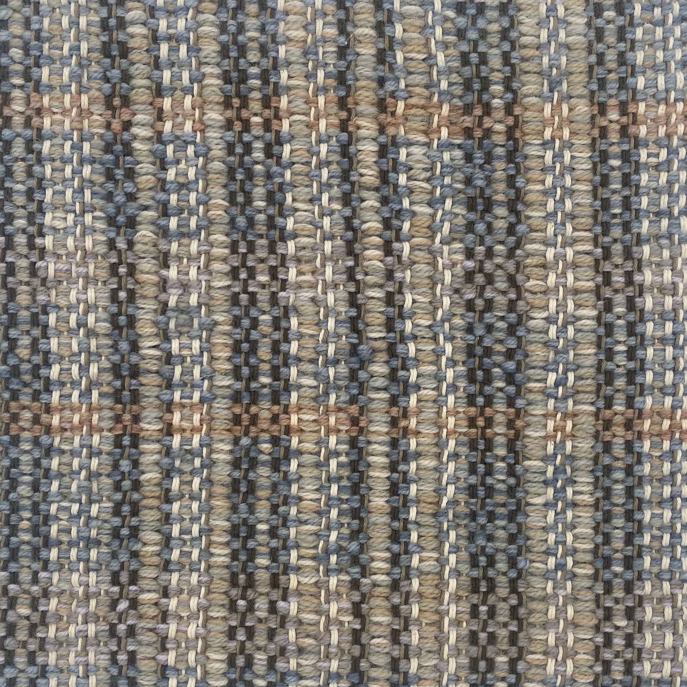 Close-up of a textured rug with a plaid pattern in shades of brown and gray.