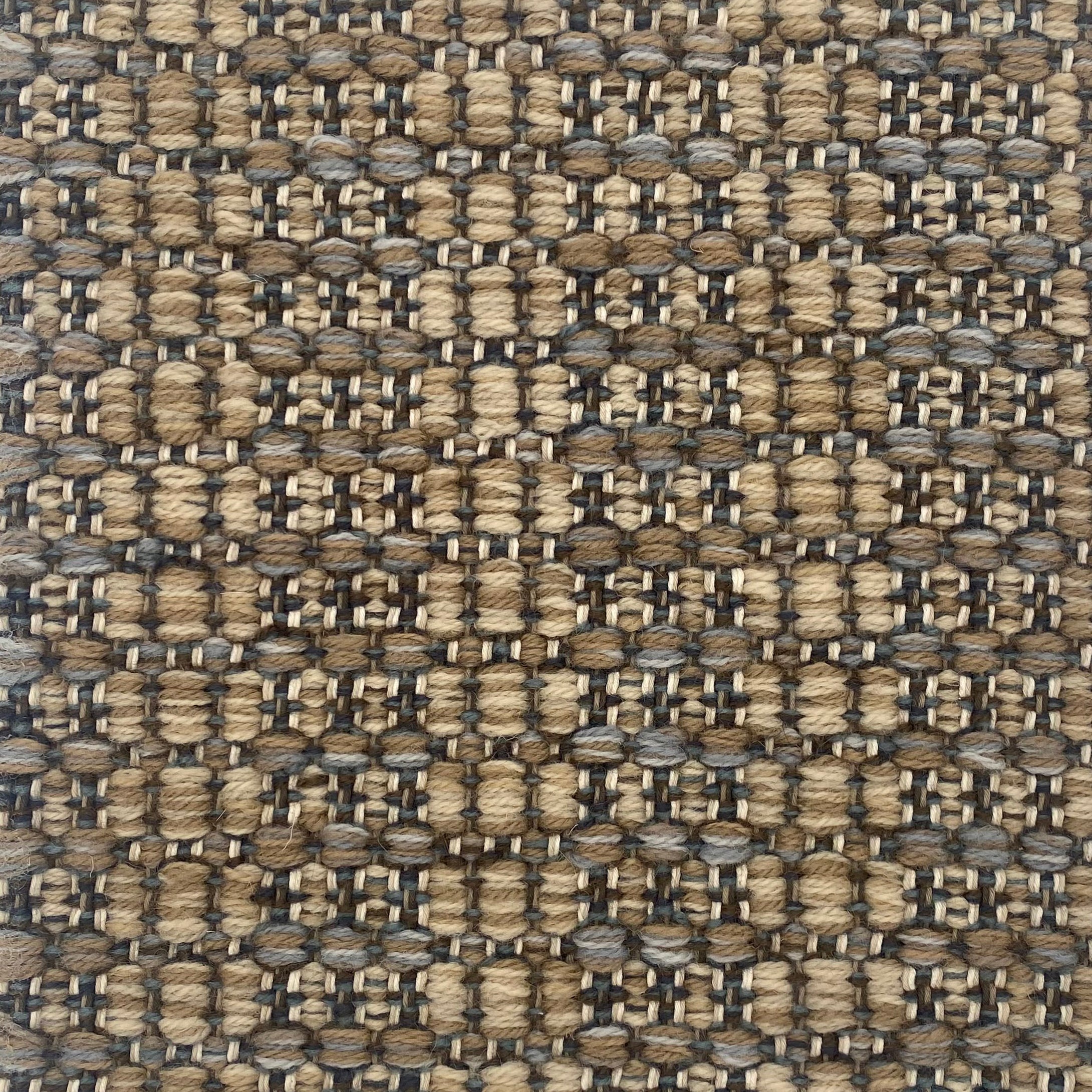Close-up of a textured brown and black woven rug