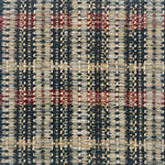 Close-up of a textured rug with a geometric pattern in teal, red and yellow.